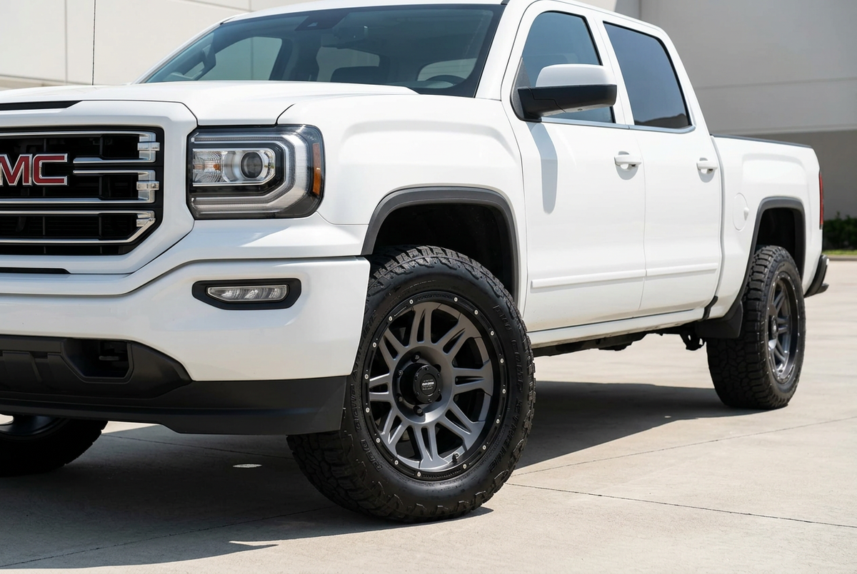 AI styling preview of graphite eight-spoke Pro Comp Torq wheels on GMC Sierra 1500, not verified fitment